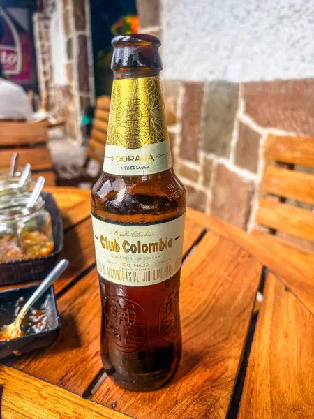 A bottle of beer on a restaurant table.