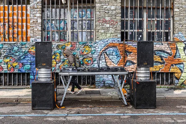 A bicycle outside a building covered with colourful graffiti.