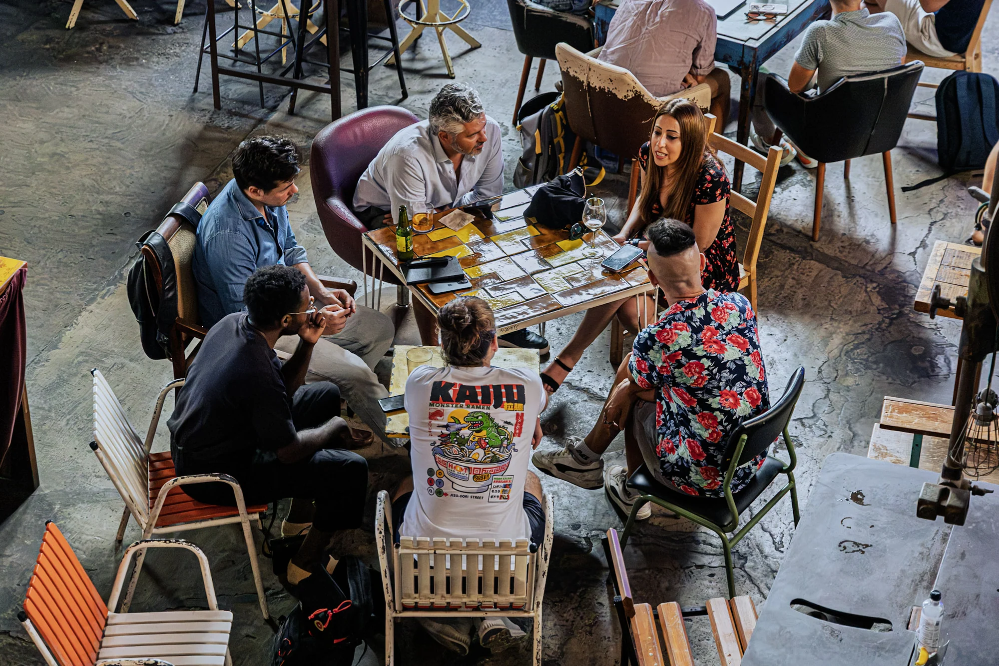 An overhead view of participants talking around a table at the event.
