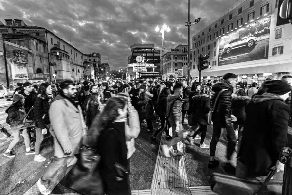 A busy shopping street photographed in black and white.