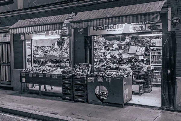 A small street kiosk in a black and white photograph.