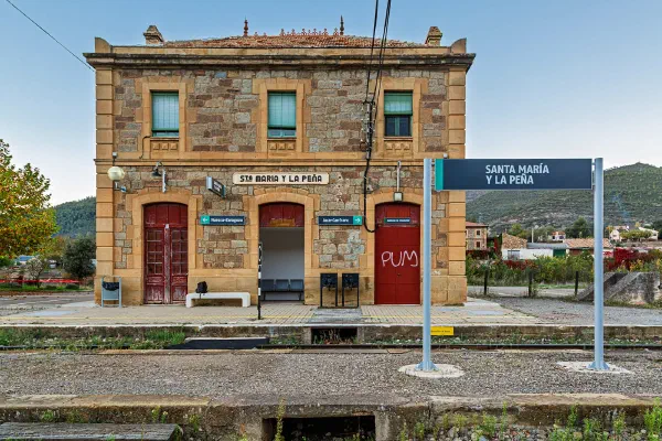 A small railway station building beside a platform.